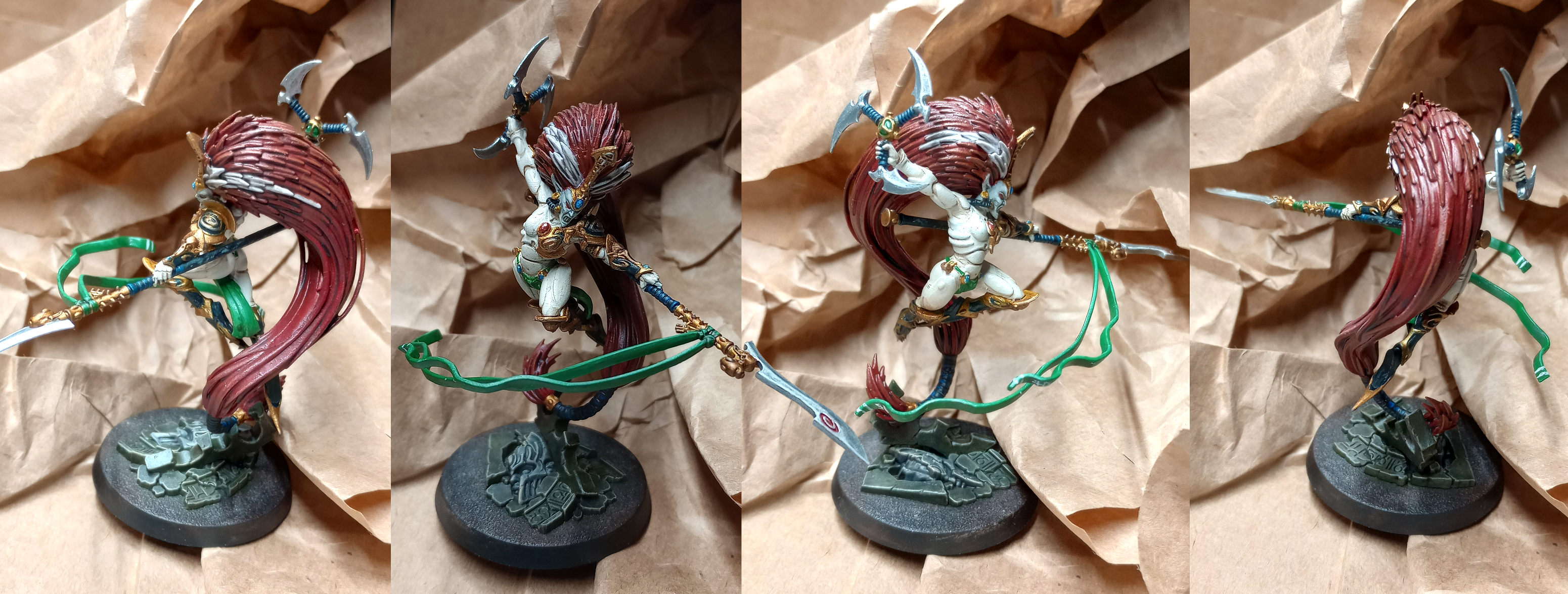 A figurine of a female space elf with very long red hair. She wears ornate armor and carries a spear and a throwing weapon; her face is hidden by a mask.