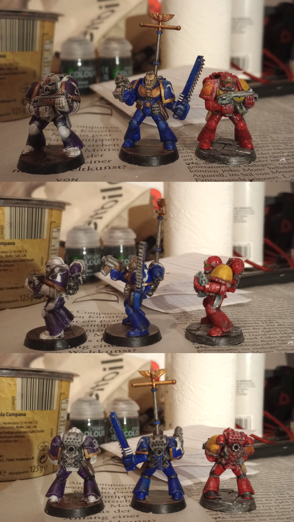 3 Warhammer 40k space marine figures photographed from different angles.