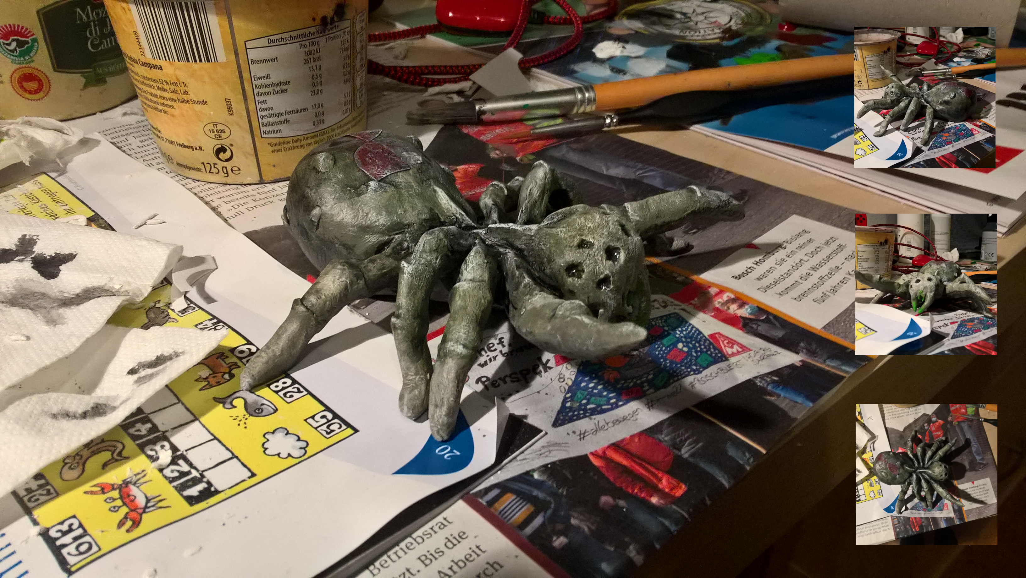 A dirty green spider sitting between art supplies.
